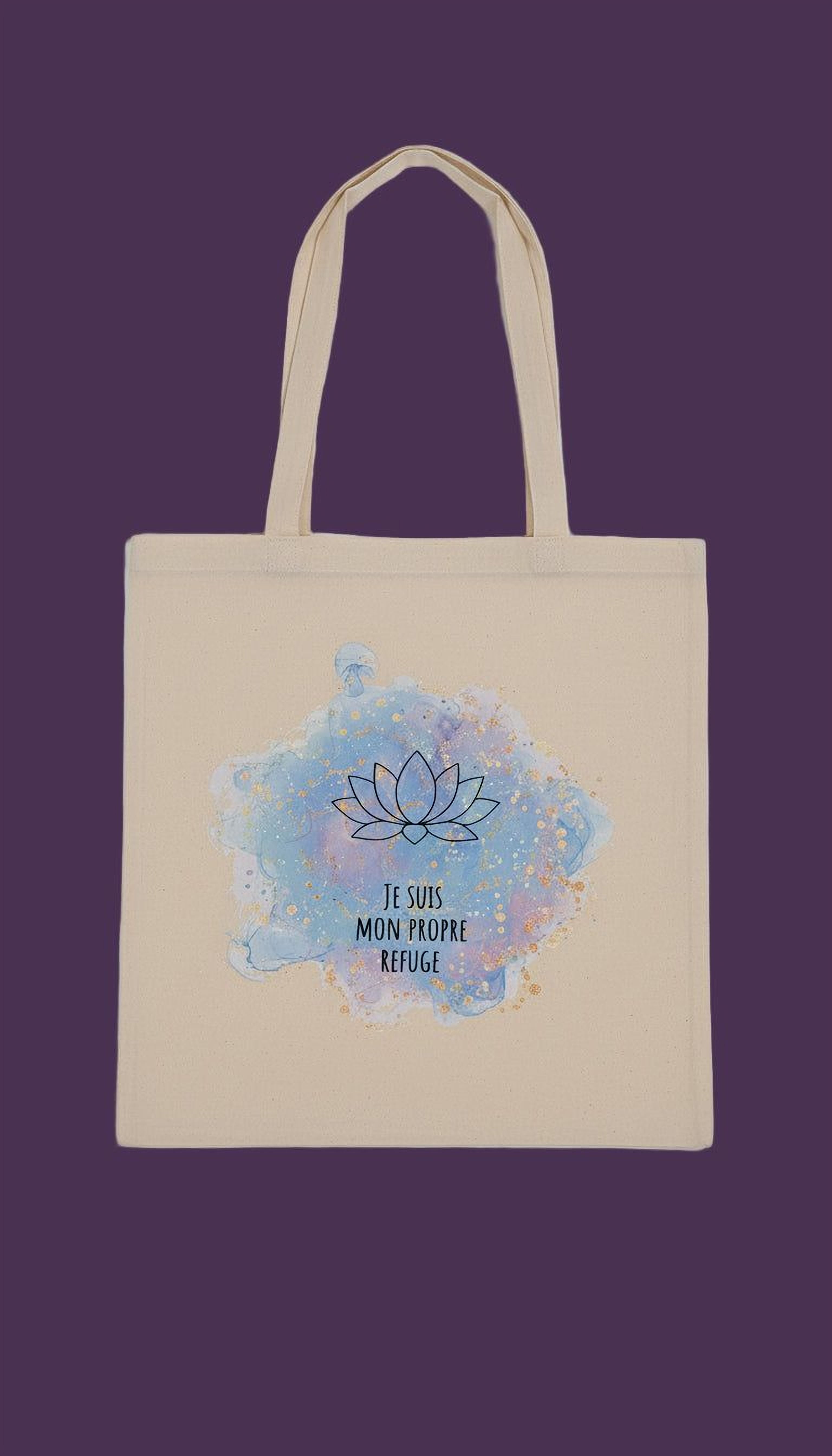 A beige canvas tote bag with a watercolor design featuring a lotus flower and the text "Je suis monde propre refuge" (I am a refugee).