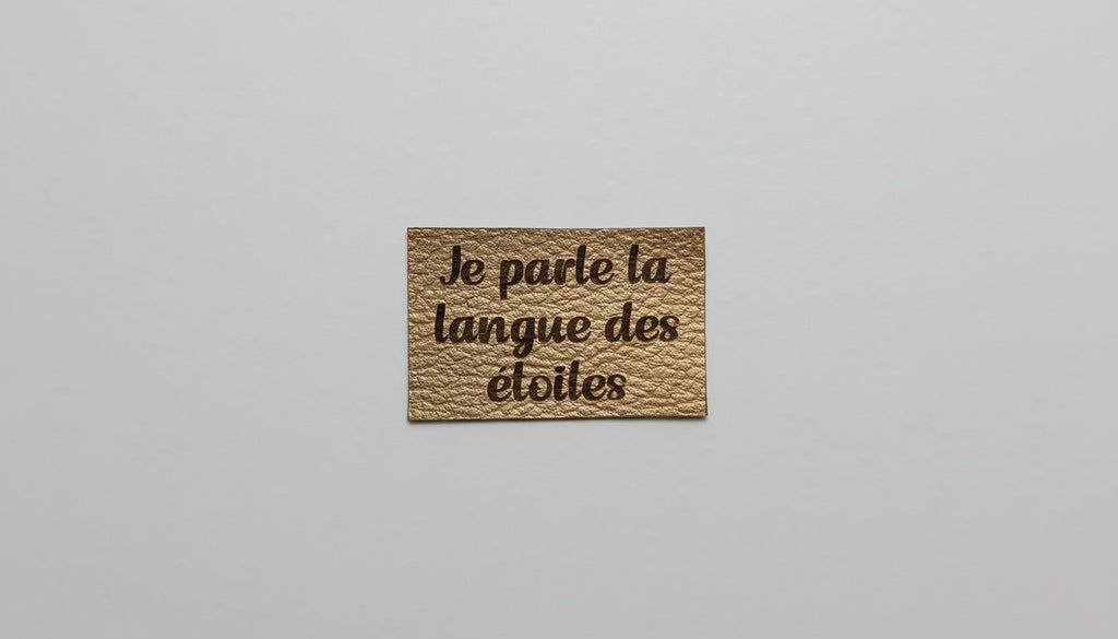 A small, square-shaped object with text on it, placed against a plain white background.