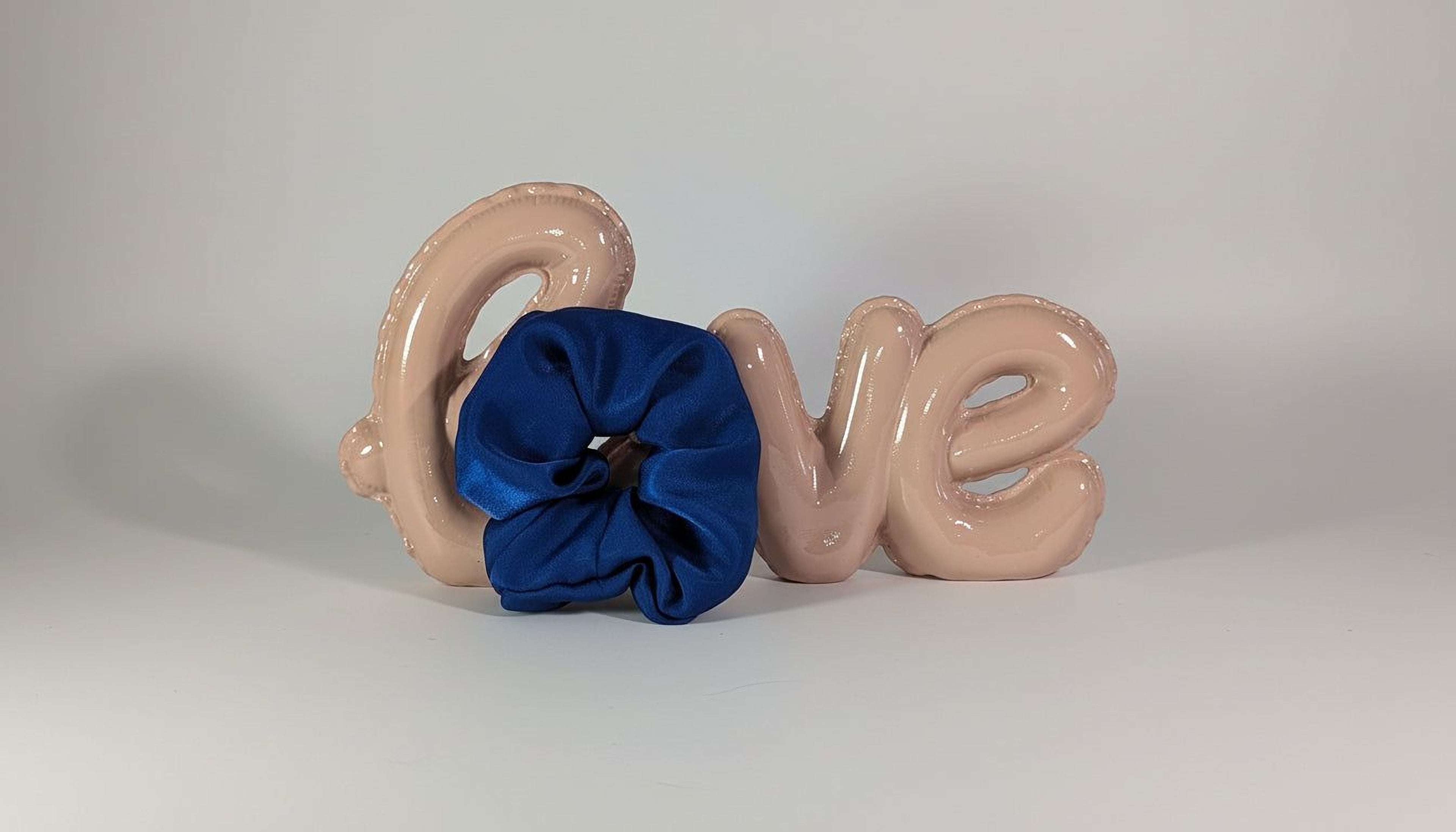 a blue ribbon and the word "Love" written in balloons.