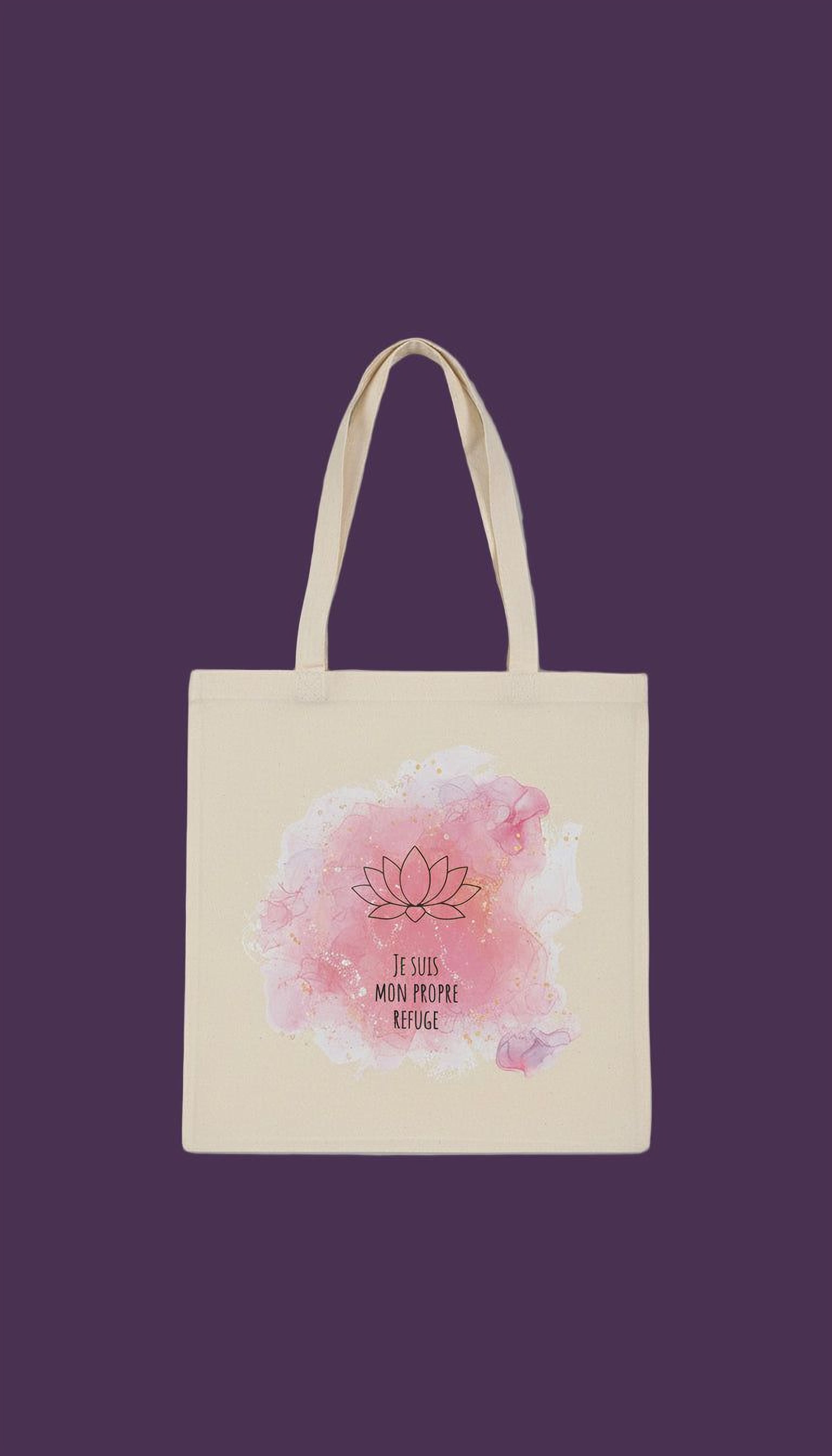 A beige tote bag with a pink watercolor design featuring a lotus flower and the text "Je suis monde propre refuge" (I am the world).